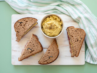 Rye bread sandwich with italian ham and avocado cashew spread