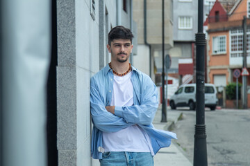 modern handsome young man with arms crossed on the street