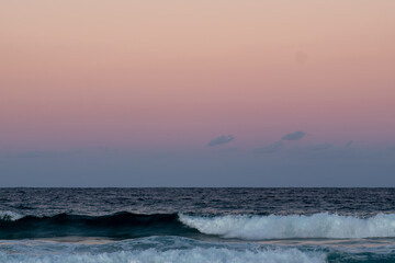 Pink sunset beach no people waves breaking