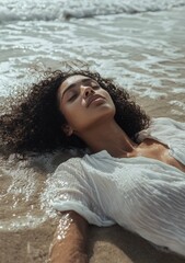 Obraz premium Gorgeous woman lying on the beach, eyes closed, ocean waves, blue sky, summer vibes
