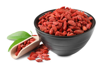 Dried goji berries in bowl and scoop isolated on white