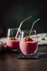 A delicious raspberry smoothie on a wooden table.