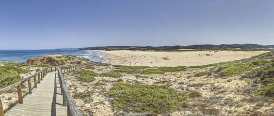 Obraz premium Panoramic image over Bordeiras Beach surf spot on the Atlantic coast of Portugal during the day