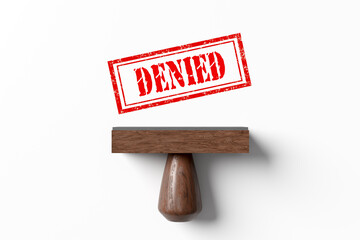 Red rubber stamp showing denied on white background