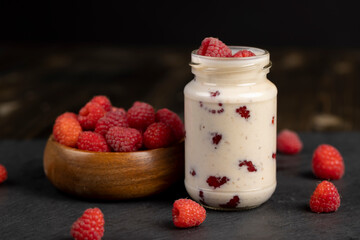 delicious and fresh yogurt with raspberry flavor and whole red raspberries