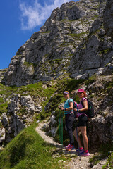Fototapeta premium Hiker women with backpacks on a trail