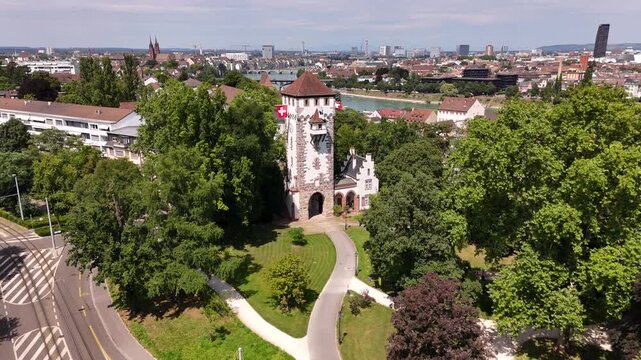 Basel's historic St. Alban gate surrounded by lush greenery and cityscape, aerial view