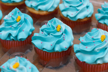 Cupcakes decorated with blue cream cheese frosting. Close up.