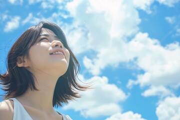 Beautiful asian woman looking at the sky with copy space for text and shine blue sky background