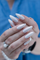 beautiful female hands with long nails light white manicure