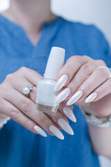 beautiful female hands with long nails light white manicure