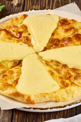 Khachapuri with Imeretian Cheese on Wooden Background - Traditional Georgian Cheese Bread