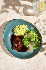 Delicious Beef Cheek with Mashed Potatoes and Mixed Greens on a Plate