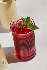 Refreshing Berry Lemonade with Fresh Mint in Sunlit Setting