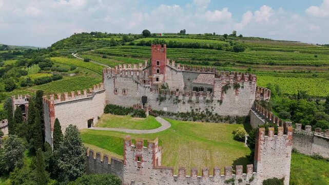 Aerial view of Soave Castle in Italy, showcasing its medieval architecture and beautiful landscape. Rising shot