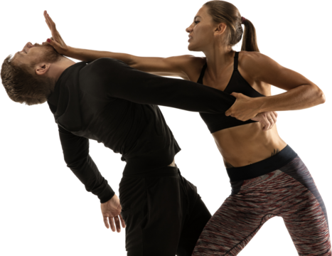 Concentrated young woman practicing palm strike with male partner isolated on white background. Self-defense, women protection, sport, safety concept. Confronting domestic violence, robbery on street