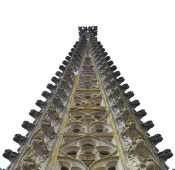A closeup of a tall building (church) on a plain white background