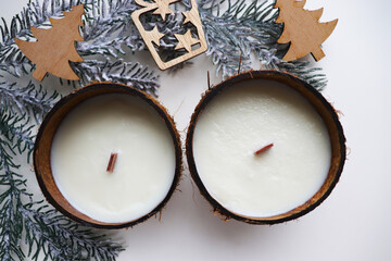 original christmas candle in coconut and fir branches	