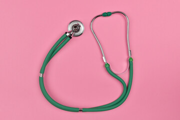 Fototapeta premium Medical equipment phonendoscope, or stethoscope, diagnostic device for auscultation isolated on pink colour background