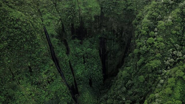 Teahupoo, Tahiti aerial drone view of the waterfalls that form the river in the valley of mountain Orohena Aorai Ronui. French Polynesia 2024 Paris Olympics surfing. Moana Disney Te Fiti inspiration.