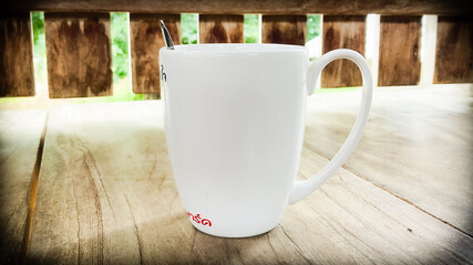 A coffee mug with a wooden lattice decoration on the back.