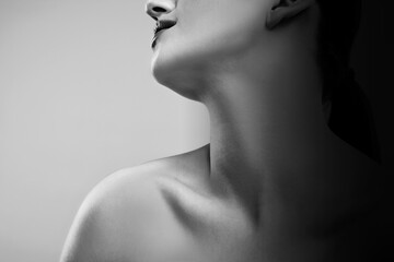 Gorgeous woman showing her beautiful neck, closeup. Black and white effect