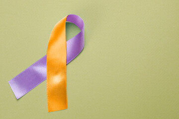 World Psoriasis Day. Orange and orchid awareness ribbon as symbol of support on olive color...