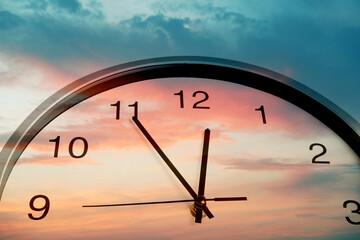 Clock and sky lit by sunset, double exposure. Time concept