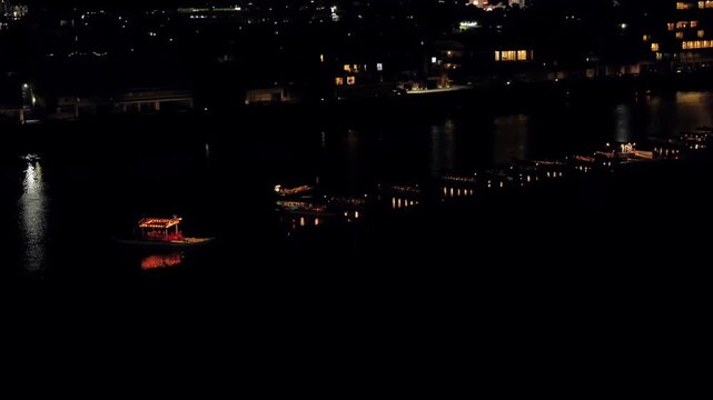 Traditional Japanese boats with lanterns parking on a quiet night on Nagara river