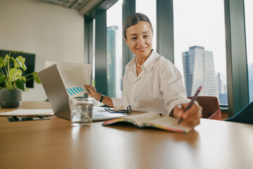 A Professional Woman Engaged in Work Within a Contemporary Office Environment Setting