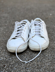 used white sneakers on a concrete background