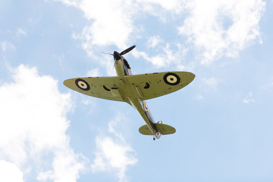Cambridge, United Kingdom - September 12 2015 - A Supermarine Spitfire World War 2 figher plane flies over the skies of Cambridge during the Dragon Boat Festival