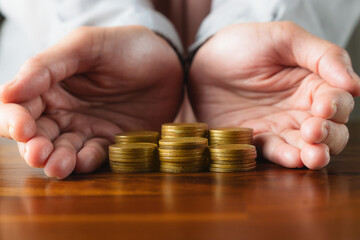 muslim businesswoman hand protect heap of coins money symbol for financial banking investment...