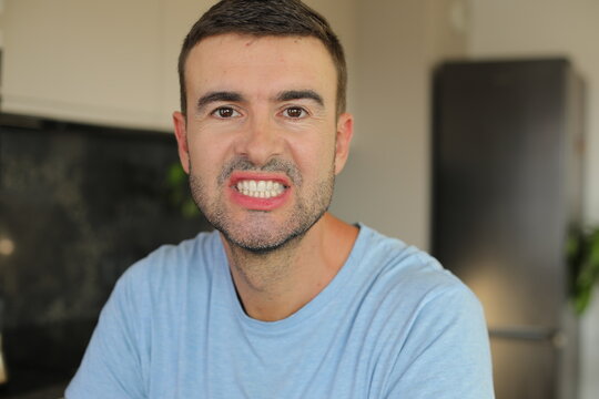 Offended man faking a smile 