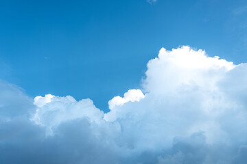 Rainy clouds transforming from white to dark and expanding on blue sky.