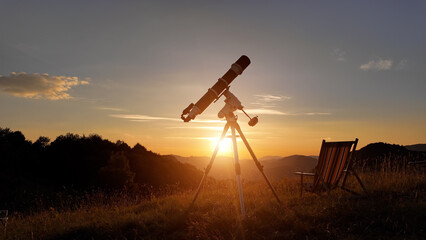 Preparing for night sky observing with a astronomical telescope just before sunset.