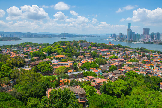 Gulangyu historic district aerial view from Mount Sunlight Rock (Lit-kong-giam, Riguangyan), with Xiamen modern skyline at the background, Fujian, China. Gulangyu is a UNESCO World Heritage Site.