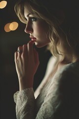 Contemplative Woman with Wedding Ring - Emotional Close-up Portrait in Dimly Lit Room