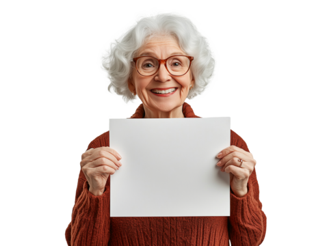 A joyful elderly woman with curly gray hair stands holding a blank sheet of paper. She wears a cozy, warm sweater, and her bright smile radiates positivity and warmth.