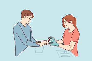 Fototapeta premium Woman does manicure for man who cares about nail hygiene and well-groomed hands, or absence of uncut cuticles. Specialist processes fingernails with file during manicure session for guy