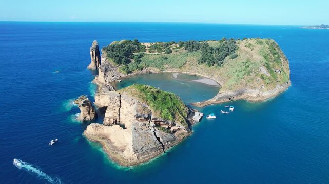 Aerial view of Ilheu de Vila Franco do Campo on a bright summer day, showcasing its turquoise lagoon and volcanic beauty off Sao Miguel, Azores, Portugal