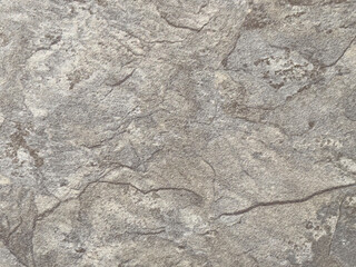 Nahaufnahme einer grauen Stein- oder Felsoberfläche aus Mamor