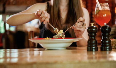 Close up view woman that is sitting in restaurant and eating food