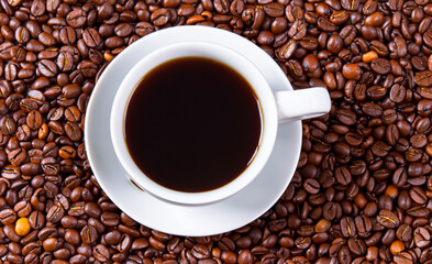Fototapeta premium Elegant view from the top cup of coffee espresso on the coffee beans backdrop glamorous delicious morning breakfast drink lifestyle background texture web template design corporate banner advertising