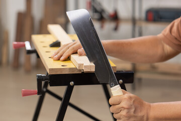 Senior man Cutting Dovetails With Woodworking Hand Tool for Hobby After retirement.