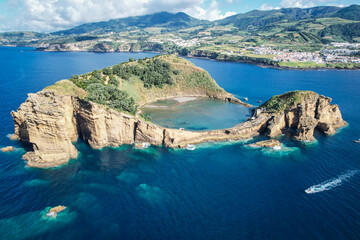 Aerial view of Ilheu de Vila Franco do Campo on a bright summer day, showcasing its turquoise lagoon and volcanic beauty off Sao Miguel, Azores, Portugal