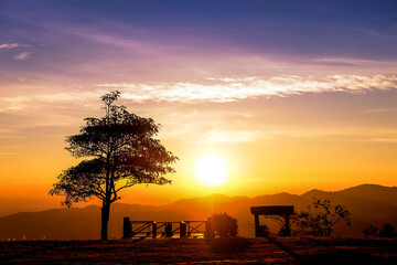 Sunset with blue sky and have the trees and mountains in a scene component.