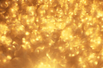 Golden glitter festive bokeh background, abstract defocused texture. Holiday lights