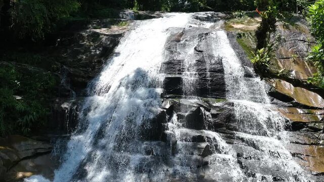 Cachoeira com &aacute;gua cristalina correndo entre as pedras na mata