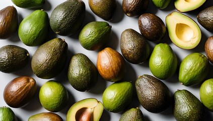 Background close-up shot of a pile of ripe brown avocados, the avocados are stacked, and light is shining through their skins.